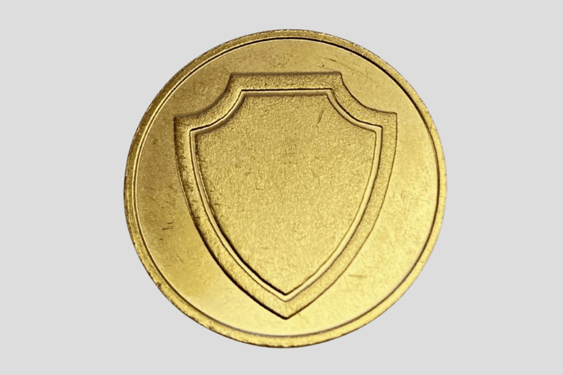 En Poletter metall preget-mynt på en grå bakgrunn, også kjent som plastpoletter eller vikingmynter av JM Band®.