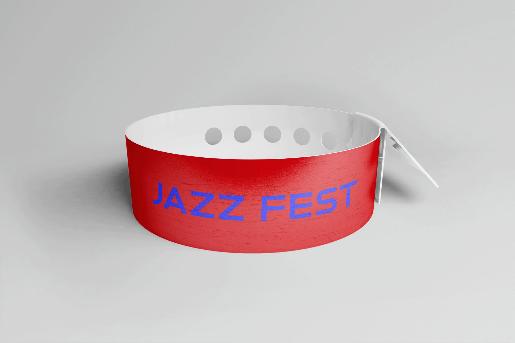 Et JM Band® Plastarmbånd L-print Design selv laget av rød PVC med ordet "jazz fest" påtrykt. Produksjonstiden for dette plastarmbåndet er minimal.