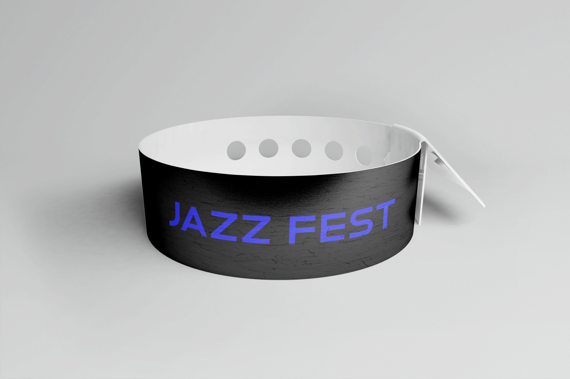Et svart PVC-armbånd med ordet jazzfest på, Plastarmbånd L-print Design selv fra JM Band®.