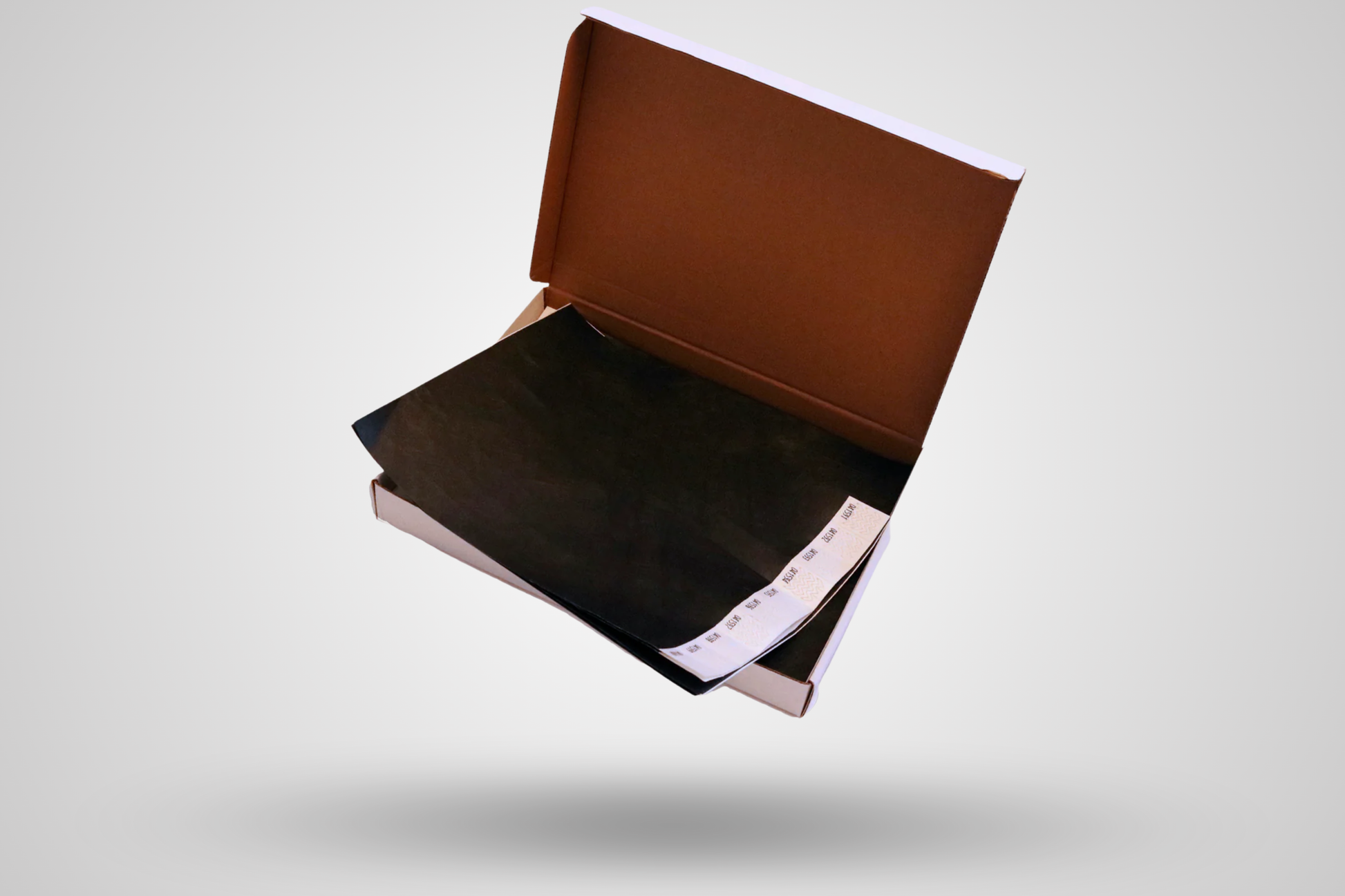 Et foto av Kasse med 1000 papirarmbånd fra JM Band®. Kjøp Papirarmbånd i Svart her.